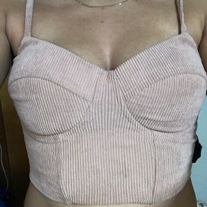 Light pink crop top, zip in the back.